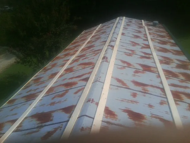 Rusted metal roof panels with new wood purlins before replacement — Storm Damage Roof Repair in Horseheads by Roofing Brothers